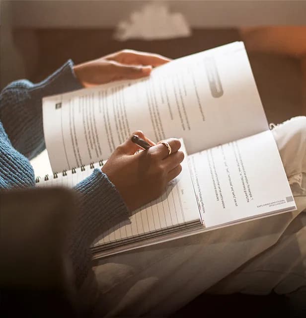 A woman participating in a Thrive programme, taking notes.
