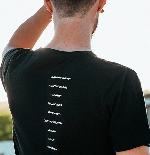 A man wearing a black t-shirt representing the culture of recovery.